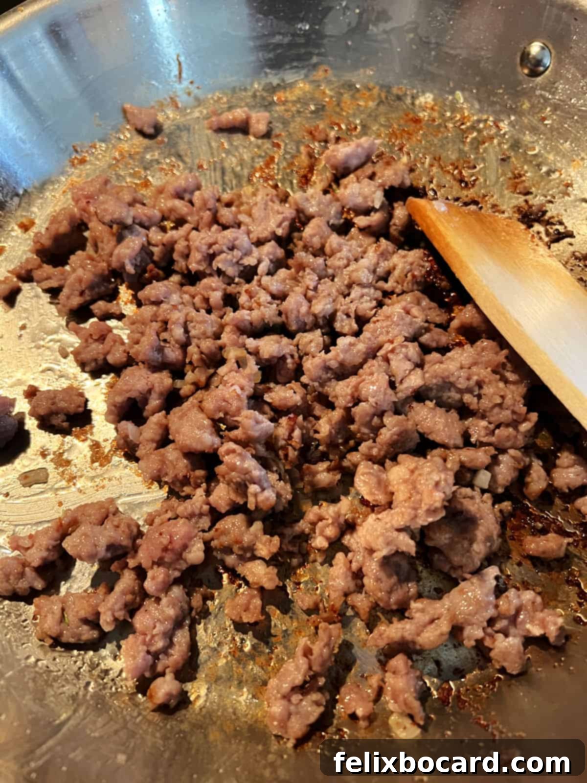 Savory Sausage and Egg Cups 5 Ground sausage cooking in a non-stick skillet, broken into small crumbles.