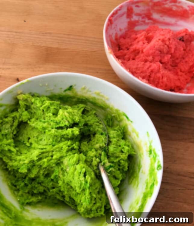 Spooky Eyeball Treats 3 Two separate bowls of cookie dough, one colored neon green and the other bright pink, ready for rolling.