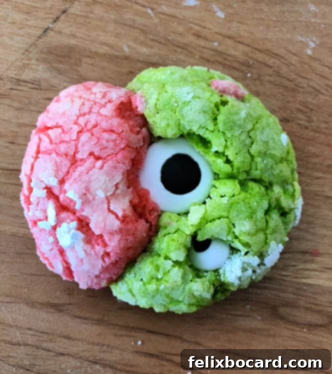 Spooky Eyeball Treats 8 A unique bi-colored monster eye cookie with green and pink swirls, adorned with multiple googly eyes.