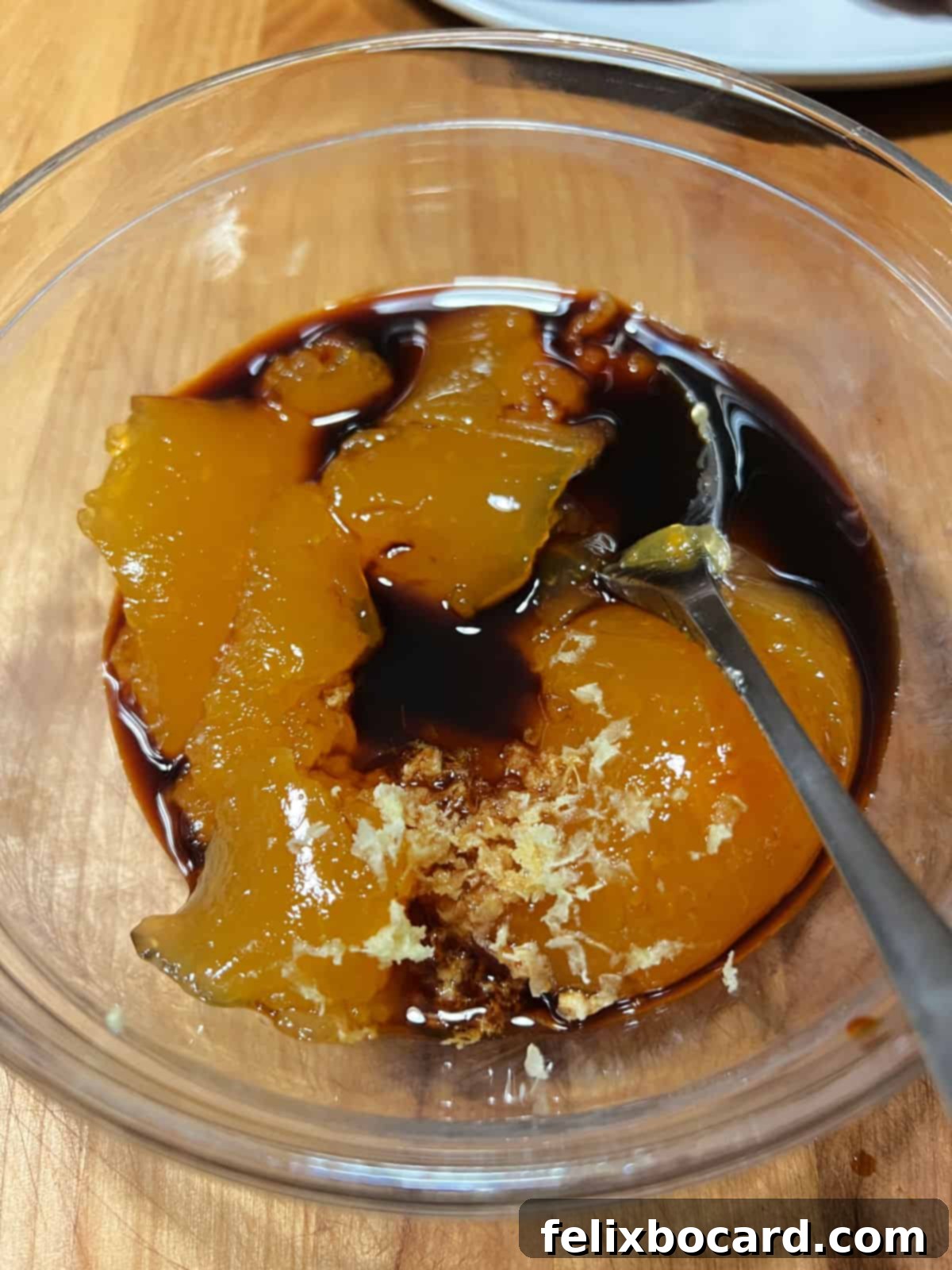 Mixing the jam with other ingredients to make the sauce.