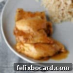 3 chicken thighs with apricot sauce on a plate ready to eat.