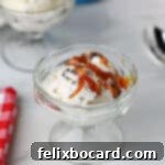 A small dessert dish with a scoop of toffee ice cream made in the Ninja Creami, drizzled with caramel sauce.