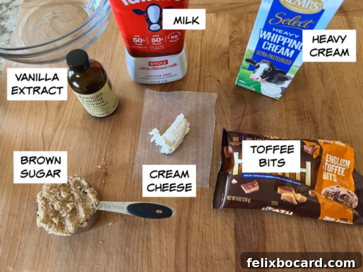 A selection of fresh ingredients laid out on a table: vanilla extract, whole milk, heavy cream, toffee bits, softened cream cheese, and brown sugar, all ready for making homemade ice cream.