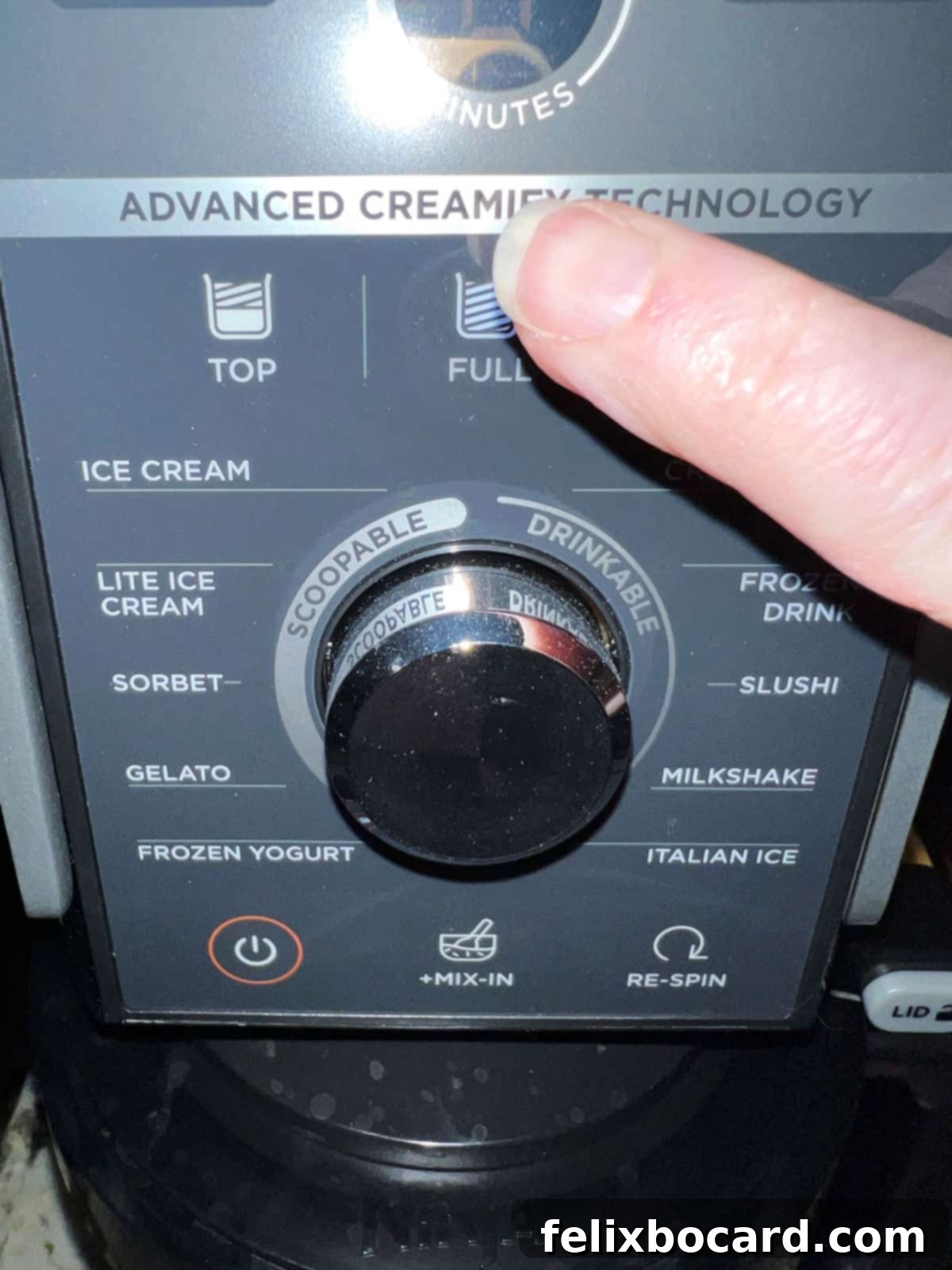 A close-up of the Ninja Creami control panel, clearly showing the 'FULL' and 'ICE CREAM' settings selected for the initial churn.