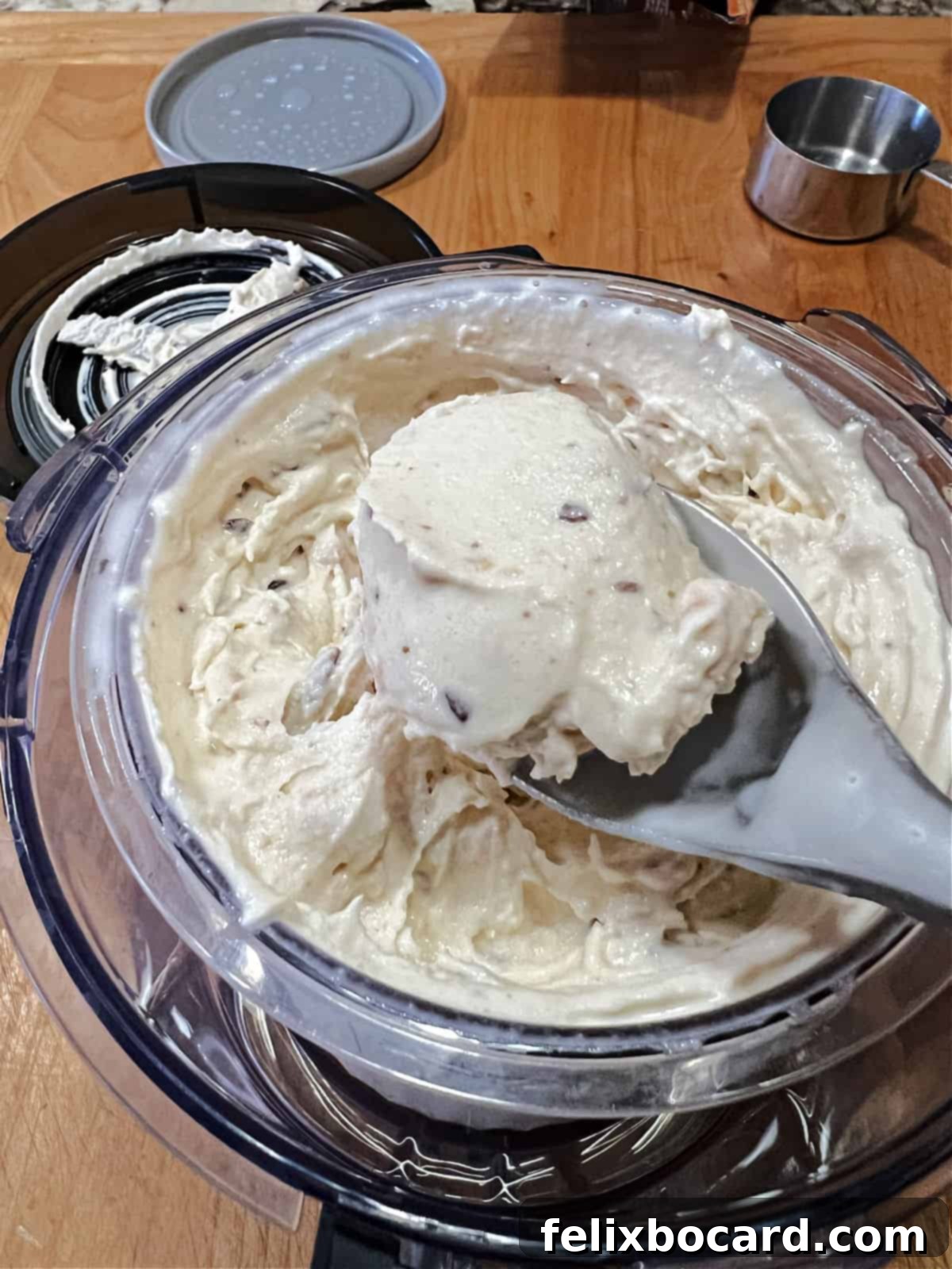 A perfectly scooped serving of homemade Toffee Ice Cream, showcasing its creamy texture and visible toffee bits, presented in a dessert cup.