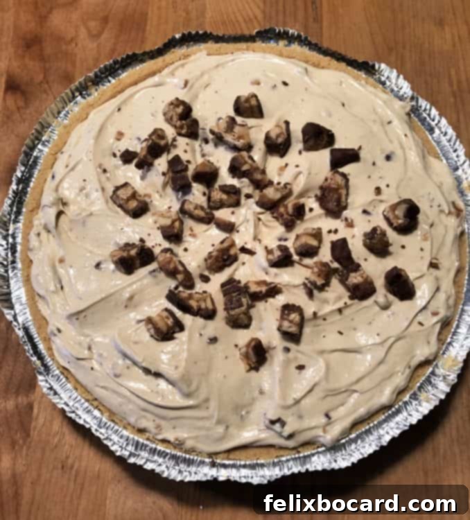 Decadent No-Bake Snickers Treat 4 Entire No Bake Snickers Pie set in its crust in a pie pan