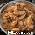 Skillet of tender chicken pieces in a rich Marsala and mushroom sauce.