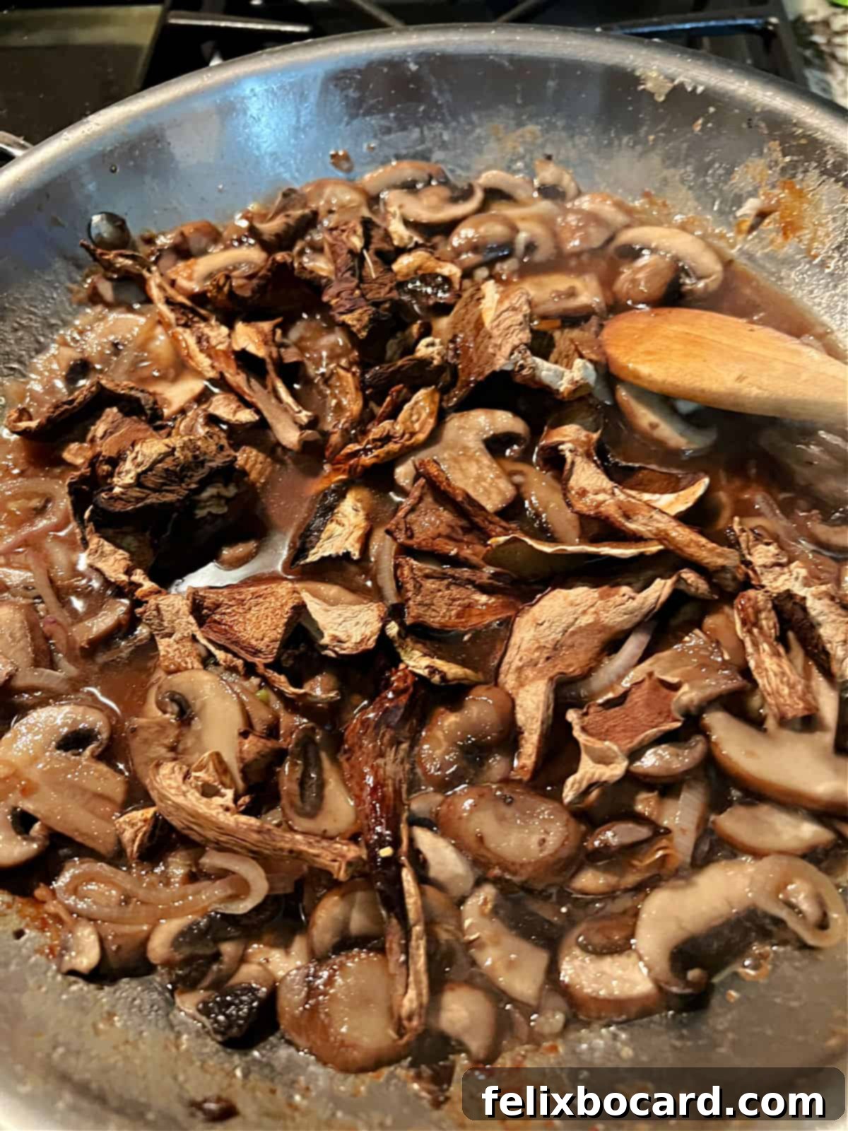 Mushroom and Marsala wine sauce simmering in a skillet, reducing beautifully.