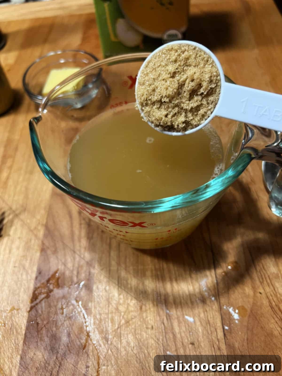 Blending the final sauce ingredients in a measuring cup.