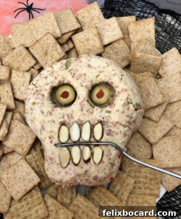 Spooky Pepperoni Skull Cheeseball 5 Pepperoni Cheese Ball with red pupils (pimento)