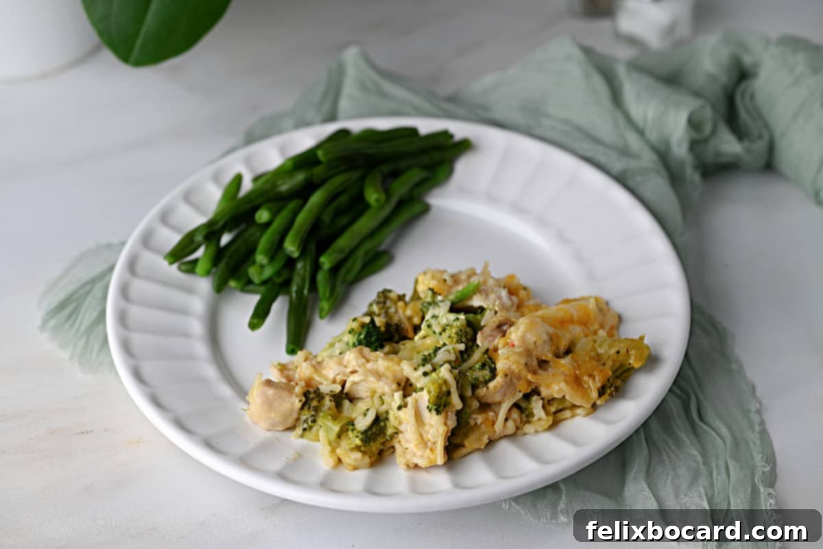 chicken broccoli rice casserole made with Knorr rice packet, served on a plate with green beans.