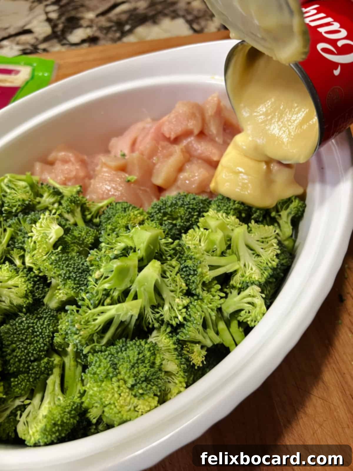 Broccoli and chicken cut up and in the dish, just starting to add soup.