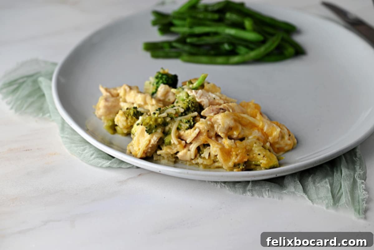 Chicken Broccoli Casserole served on a plate with some green beans.