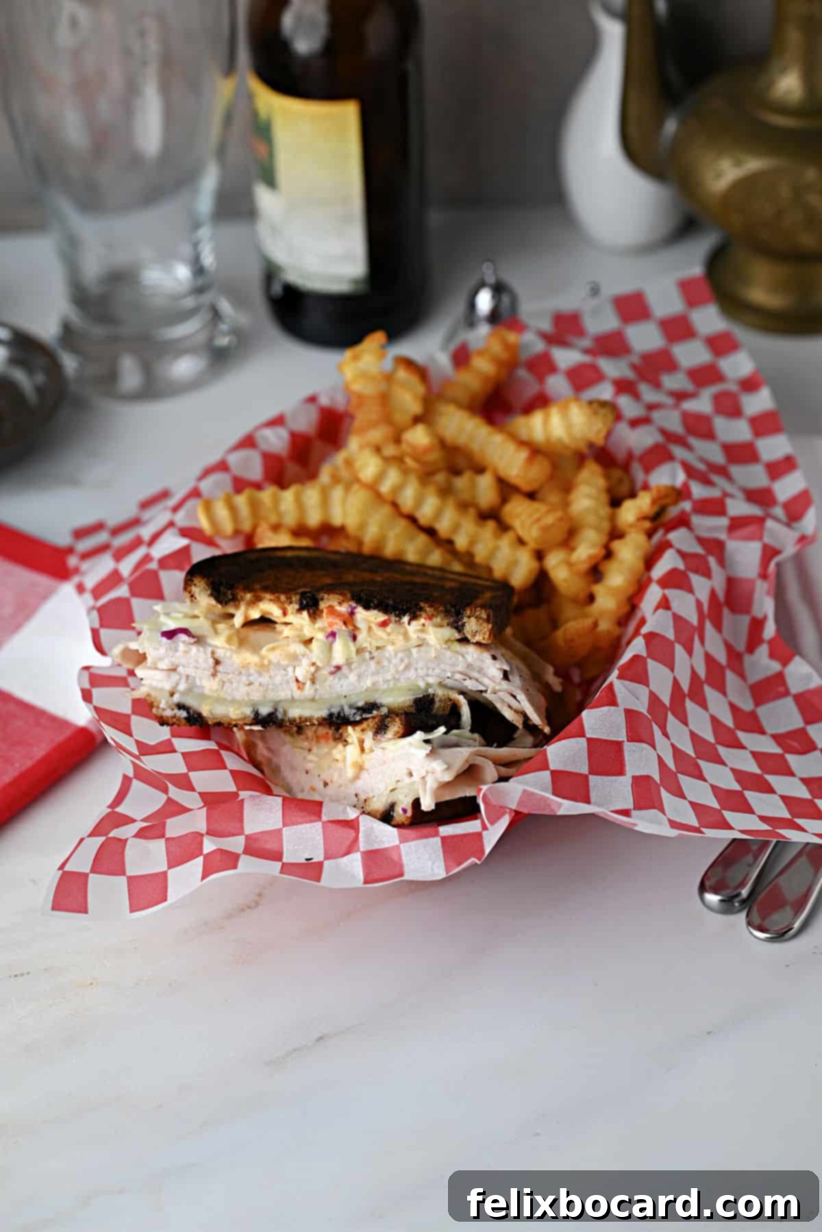 Golden Grilled Turkey Reuben 14 Grilled turkey Reuben (Rachel sandwich) served with fries in a deli style basket.