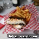 Golden Grilled Turkey Reuben 15 Rachel sandwich (grilled turkey Reuben) served in a deli style basket with French fries.