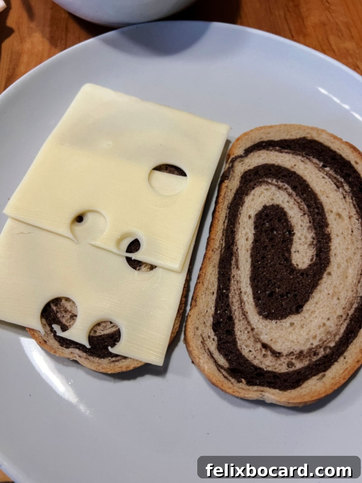 Golden Grilled Turkey Reuben 7 Placing Swiss cheese on the bread to start to build the sandwich.