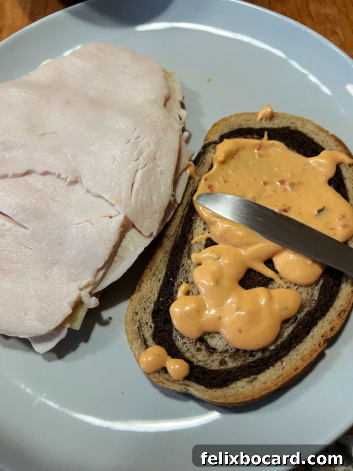 Golden Grilled Turkey Reuben 8 Adding turkey and salad dressing to the sandwich.