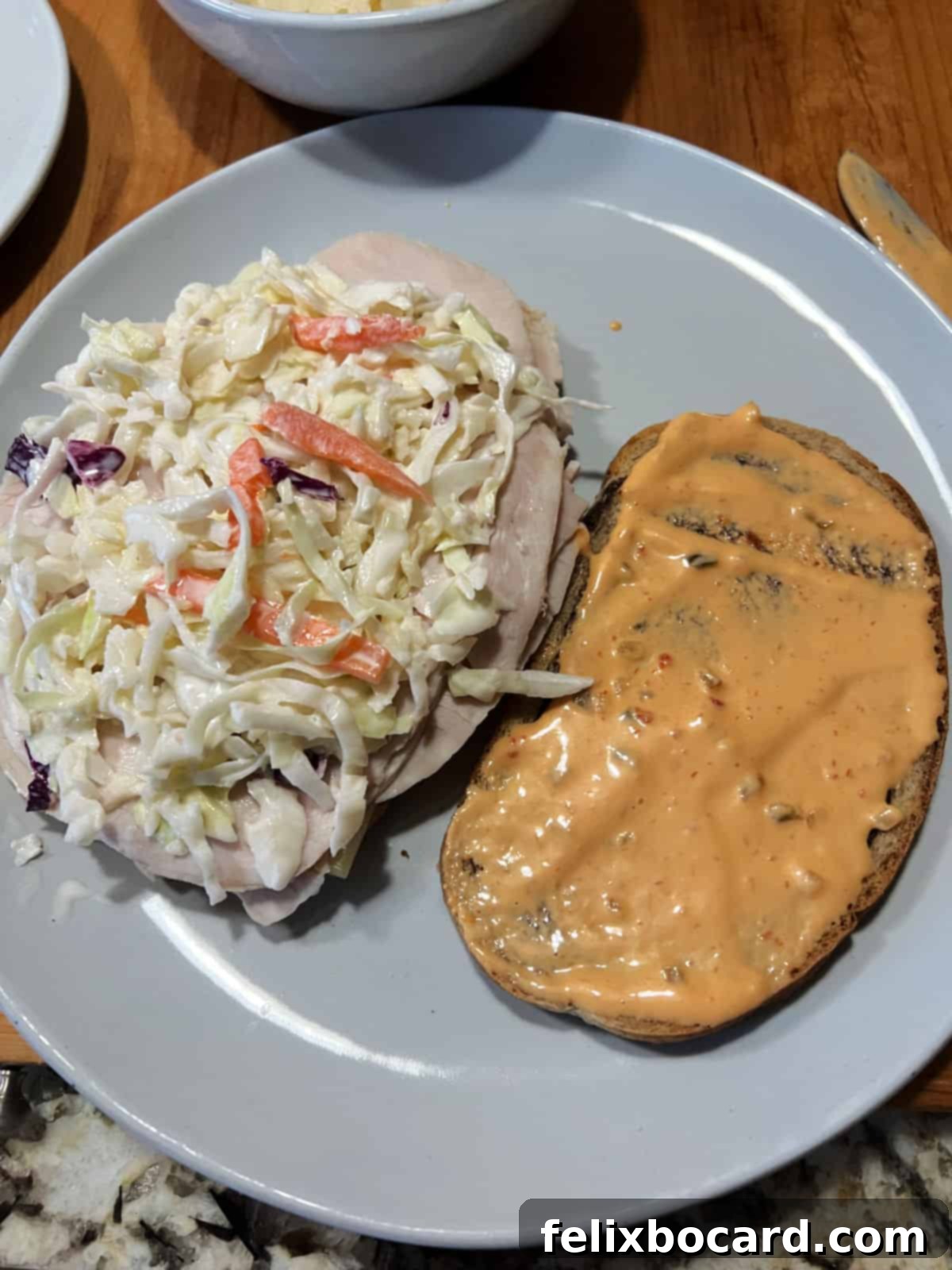Golden Grilled Turkey Reuben 9 Adding coleslaw to the sandwich.