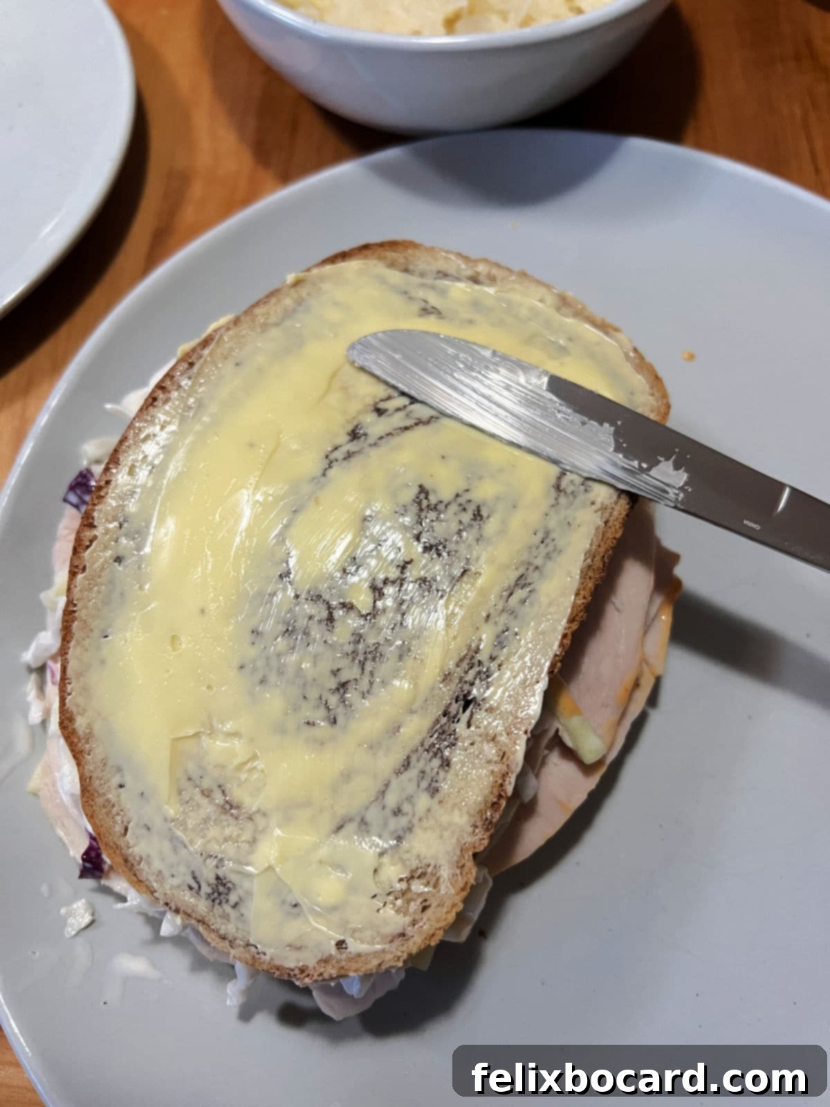 Golden Grilled Turkey Reuben 10 Buttering one side of the sandwich.