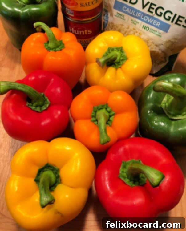 Jack-o'-Lantern Stuffed Bell Peppers 3 Ingredients laid out for making stuffed peppers, including bell peppers, ground beef, rice, and tomato sauce.