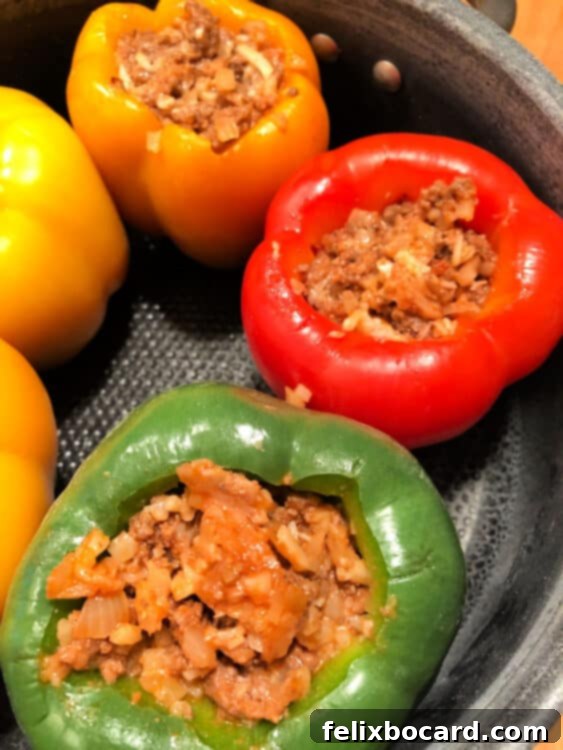Jack-o'-Lantern Stuffed Bell Peppers 4 Top-down view of a pot filled with stuffed peppers, ready for baking.