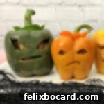 Jack-o'-Lantern Stuffed Bell Peppers 7 Two of the carved Jack O'Lantern peppers, showcasing their intricate and fun faces.