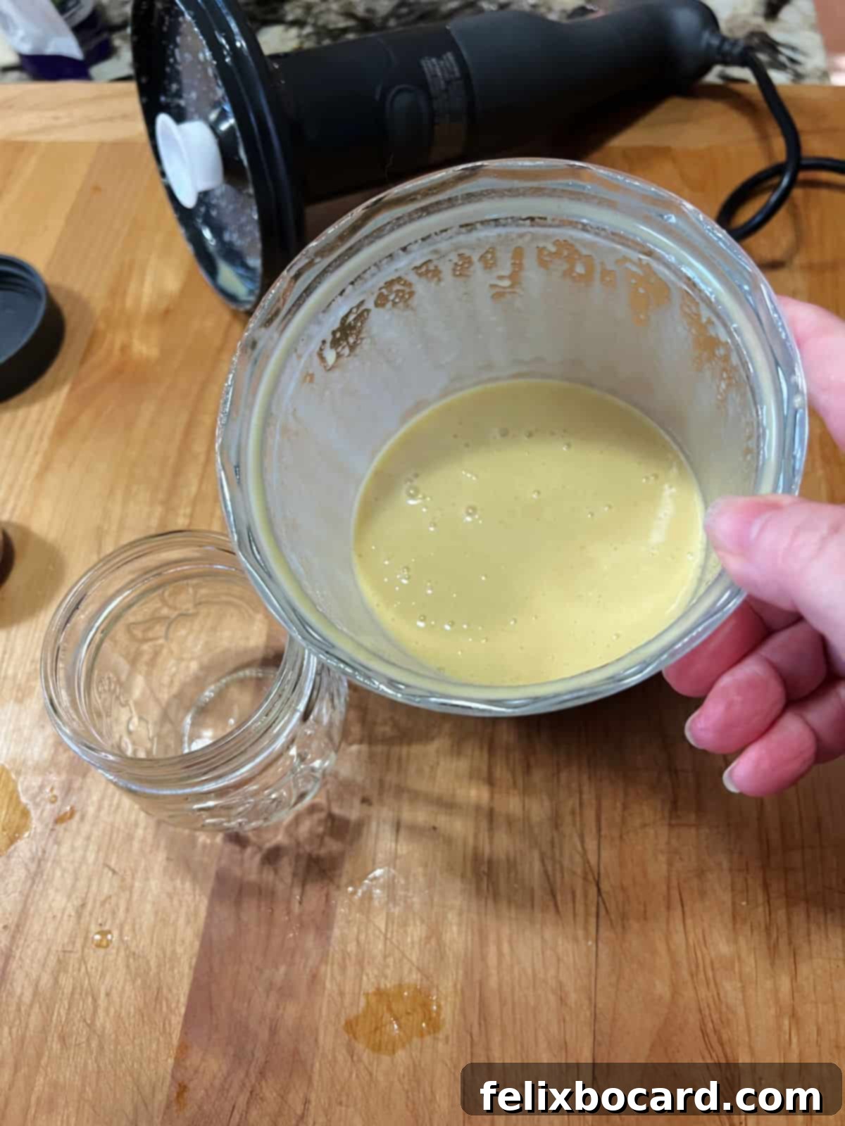 The honey lime dressing has been perfectly blended into a smooth, creamy texture in a blender container.