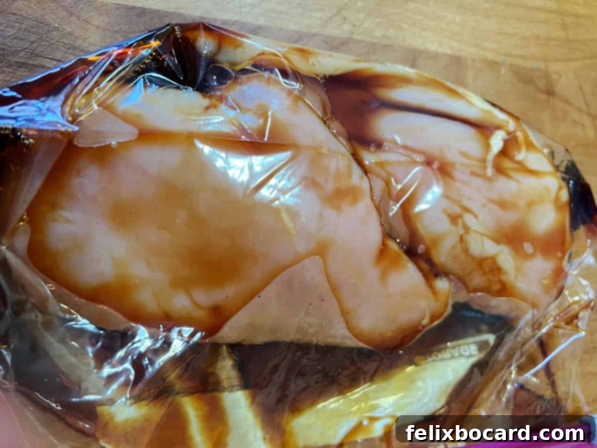 chicken breasts with marinade in a plastic bag.