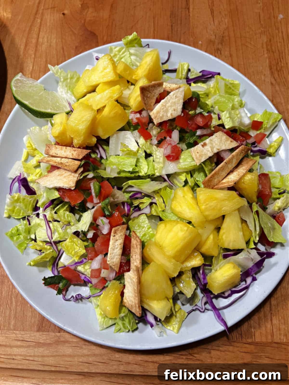 Salad ingredients getting assembled on a plate.