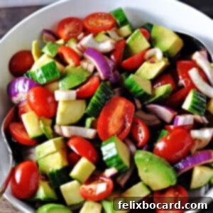 Close-up of a refreshing balsamic cucumber and tomato salad, featuring crisp cucumbers, ripe tomatoes, and creamy avocado, dressed in a tangy balsamic vinaigrette.