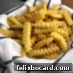 Golden brown french fries, perfectly cooked from frozen using an Instant Pot air fryer lid, served as a tempting side dish.