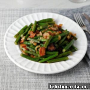 A serving of Texas Roadhouse style green beans with crispy bacon, presented on a rustic plate, inviting and flavorful.