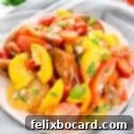 A colorful Heirloom Tomato Salad artfully arranged with balsamic glaze and feta cheese, ready to be served.