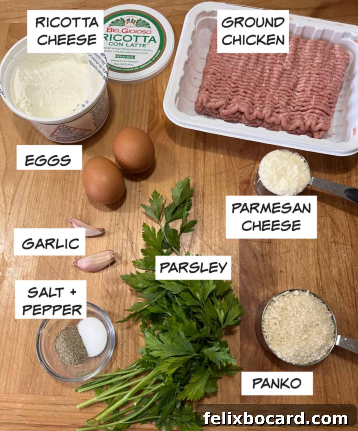 A selection of ingredients laid out, including ricotta cheese, ground chicken, eggs, parmesan cheese, panko bread crumbs, garlic, parsley, salt, and pepper.