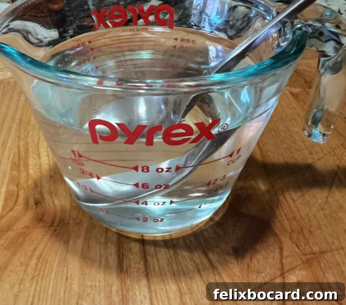 Sugar completely dissolved in water, forming a clear simple syrup.