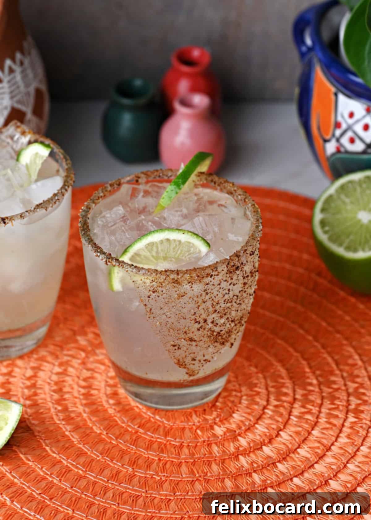 Two Chili's copycat Patron margaritas garnished with fresh lime slices, ready to be served alongside delicious appetizers.