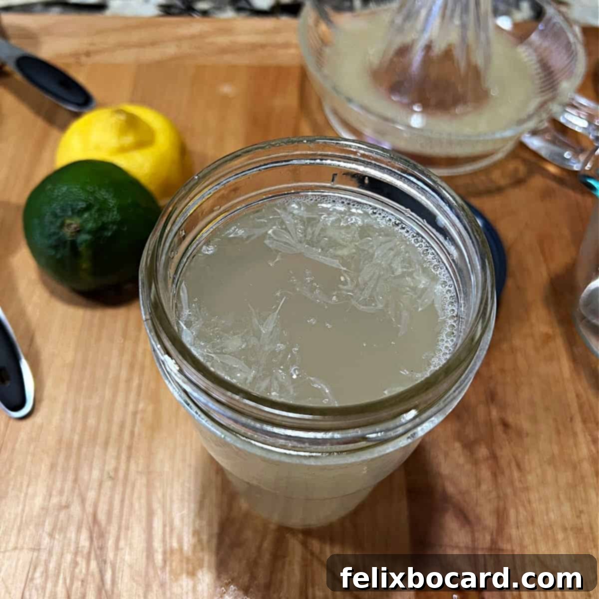A mason jar filled with vibrant, freshly made homemade sweet and sour mix, ready for cocktail creation.