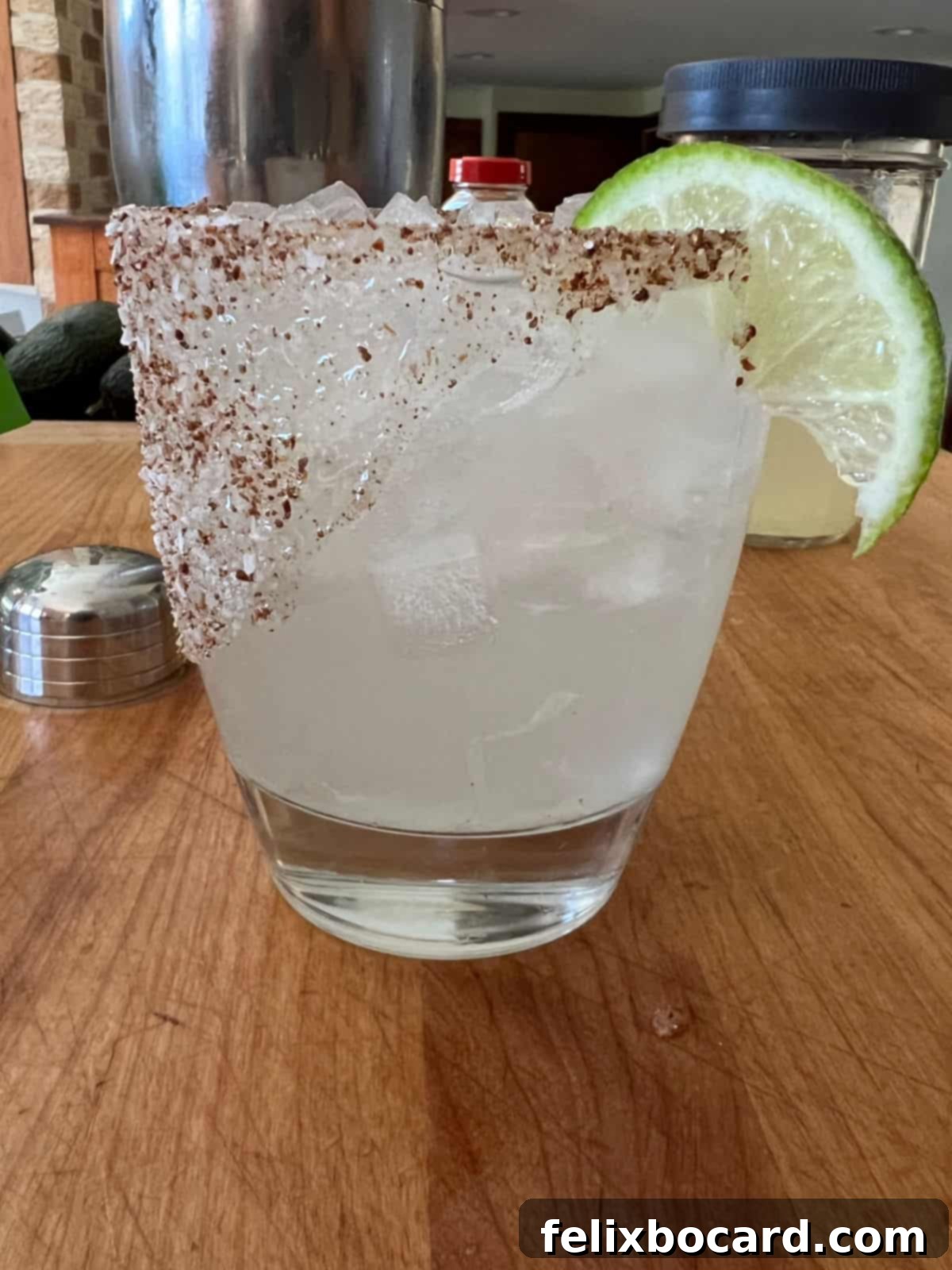 A beautifully prepared Patron Margarita, garnished with a vibrant lime wedge, ready to be enjoyed.