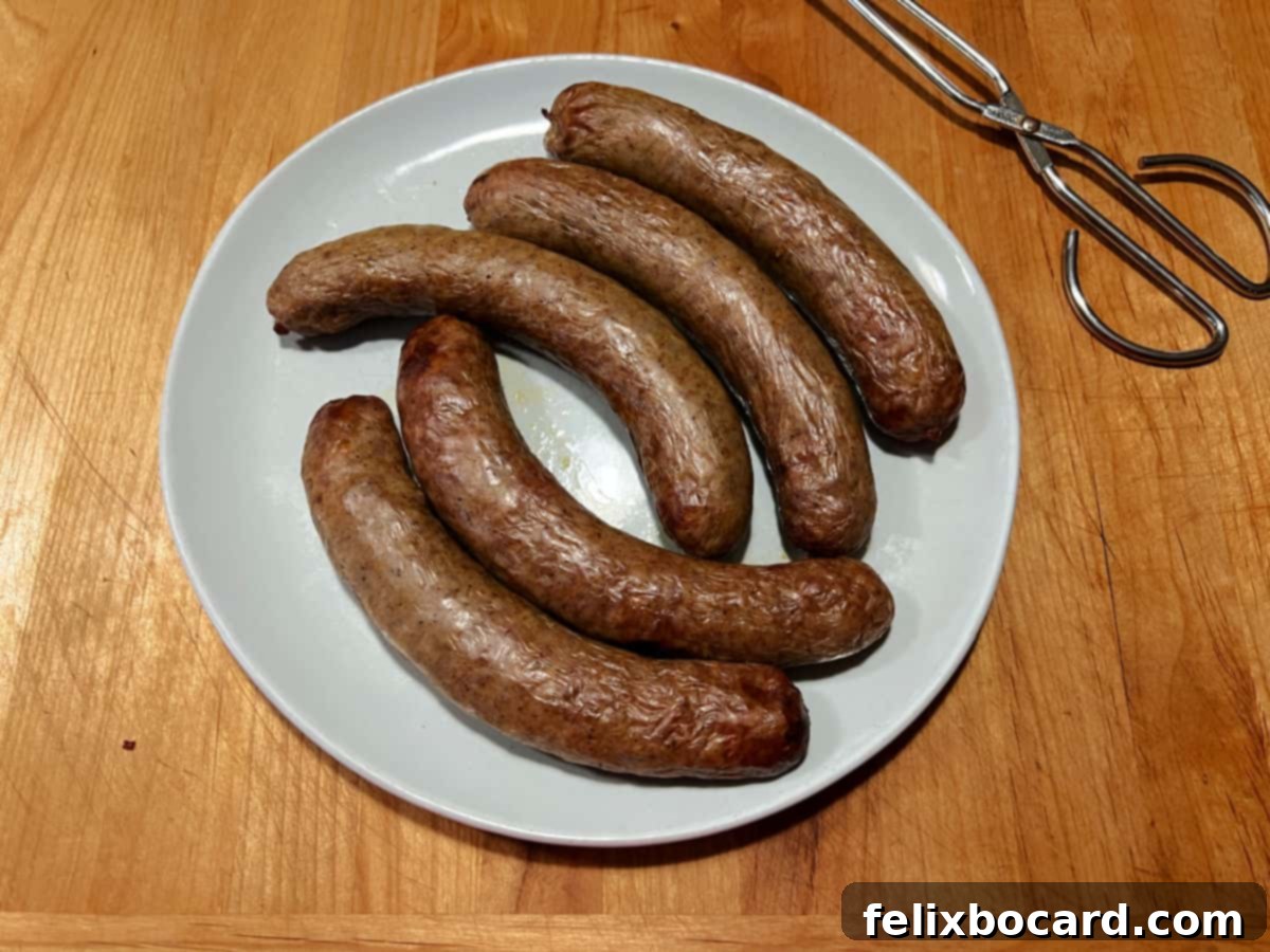 A plate of Italian sausages cooked in the air fryer, garnished with fresh herbs.