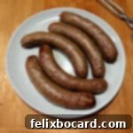 A plate of 5 Italian sausages cooked in the air fryer.