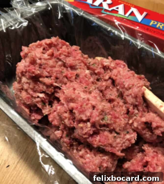 Ultimate Comfort Meatloaf 3 Meatloaf mixture in a plastic-lined loaf pan