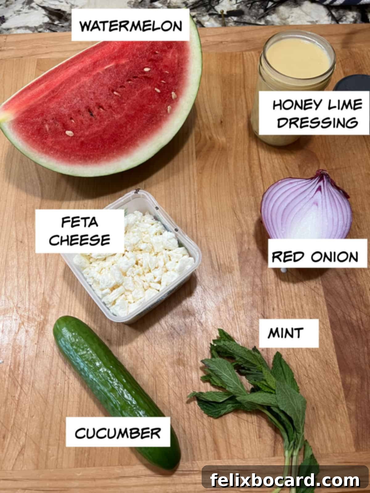 Ingredients for Watermelon Feta Salad: watermelon, honey lime dressing, red onion, feta cheese, cucumber, and fresh mint.