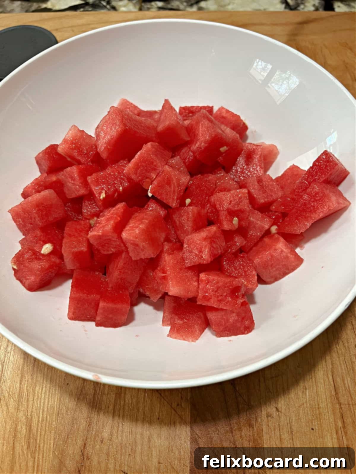 Cubed watermelon in a bowl, ready for the other salad ingredients.