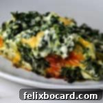 A serving of cheesy spinach casserole, perfectly portioned and ready to be enjoyed.