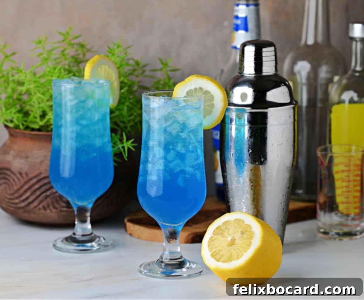 Two glasses of electric lemonade, garnished with lemon slices, ready to drink and looking refreshing.