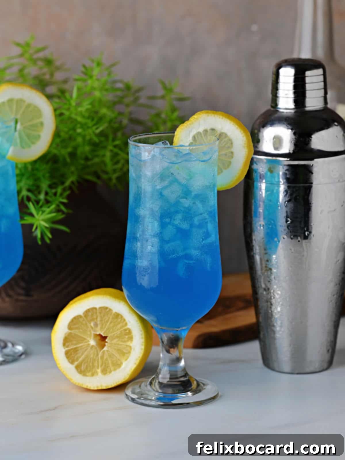 Electric blue lemonade drink ready to serve, garnished with a lemon slice and a maraschino cherry.