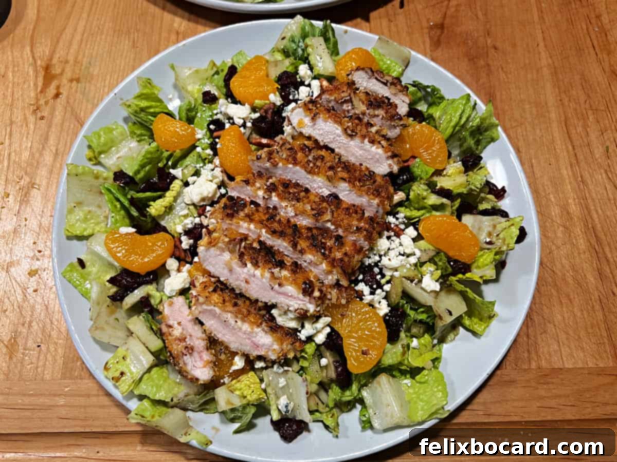 A perfectly assembled Pecan Crusted Chicken Salad, garnished and ready to be enjoyed.