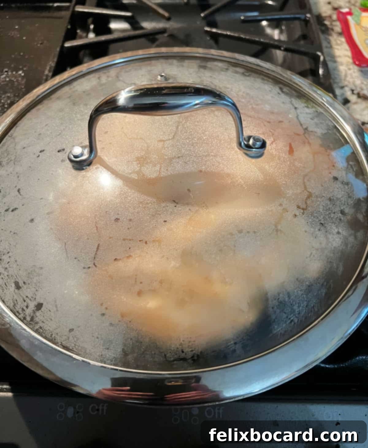 Resting the meat in a covered pan.