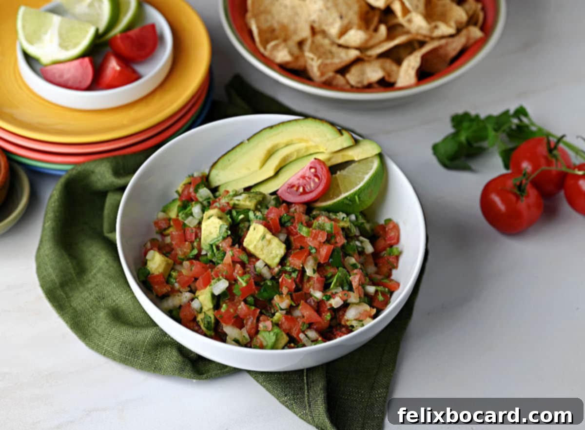 Avocado Pico de Gallo 2 A bowl of creamy Pico de Gallo with avocado served with tortilla chips.