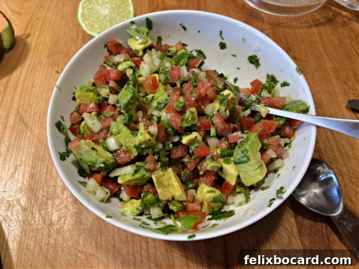 Avocado Pico de Gallo 8 Fresh Pico de Gallo with avocado added in, presenting a delicious creamy texture.